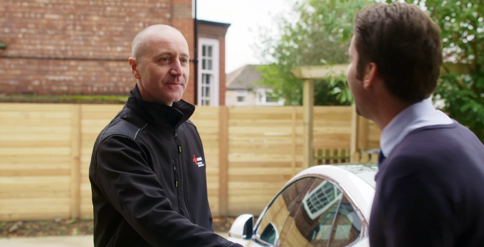 An NICEIC approved contractor shaking hands with a client outside of the client household.