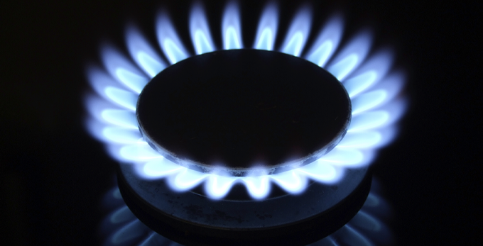 Close up view showing a gas cooker flame, with reflection.