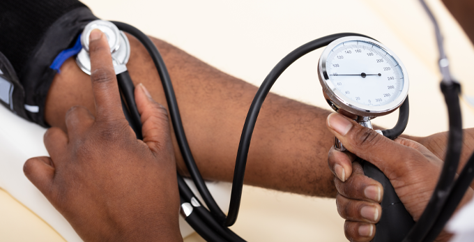 close up of a doctor measuring the blood pressure of a male patient