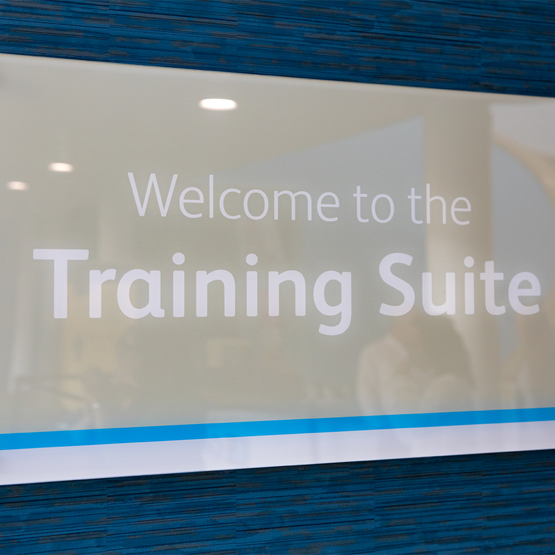 Image of training suite, glass panel reading 'Welcome to the Training Suite' 